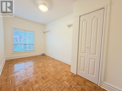 A room with a wooden floor and a white door.
