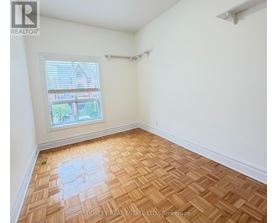 A room with wooden flooring and a window.