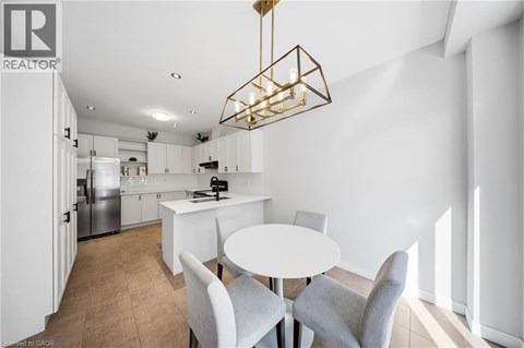 A modern kitchen with a dining table and chairs.