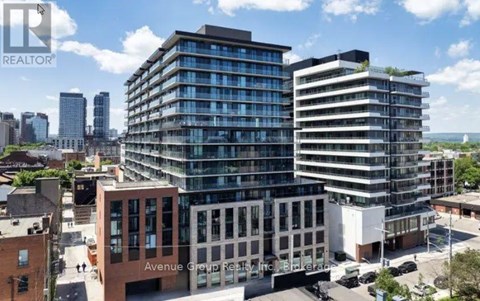 A real estate company logo is displayed on a building in a cityscape.