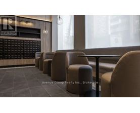 A row of brown chairs are lined up in front of a blackboard with the word "REALTOR" written on it.