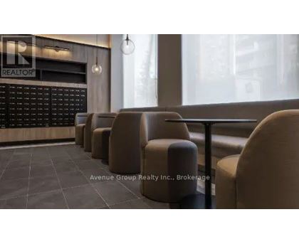 A row of brown chairs are lined up in front of a blackboard with the word "REALTOR" written on it.