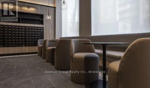 A row of brown chairs are lined up in front of a blackboard with the word "REALTOR" written on it.