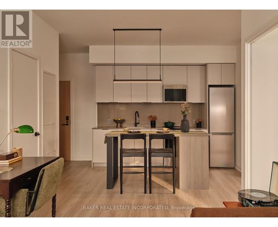 A modern kitchen with a dining table and chairs.