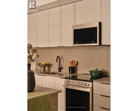 A modern kitchen with a stove top oven and a microwave above it.