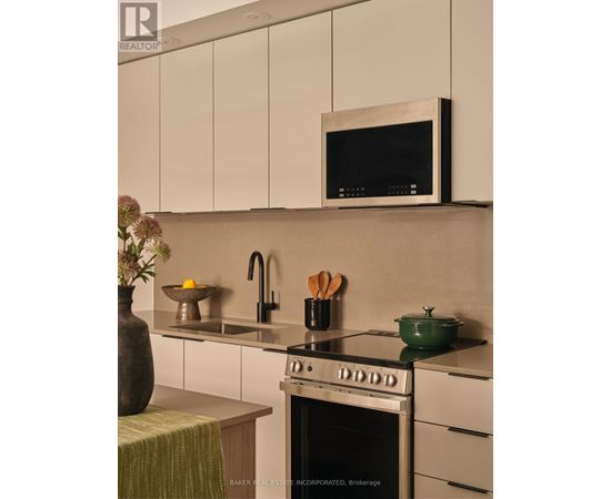 A modern kitchen with a stove top oven and a microwave above it.