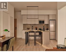 A modern kitchen with a dining table and chairs.