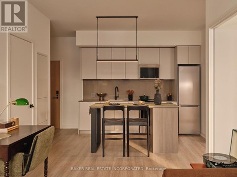 A modern kitchen with a dining table and chairs.