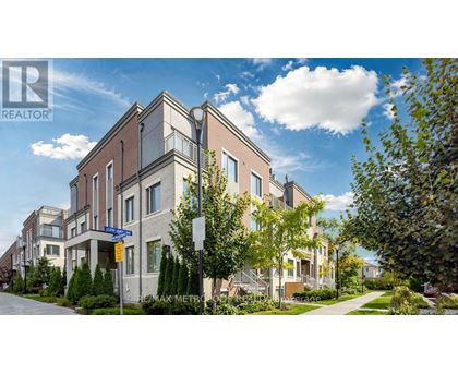 A modern apartment building with a clear blue sky above.