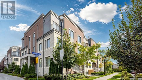 A modern apartment building with a clear blue sky above.