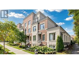 A row of houses with a realtor logo in the corner.