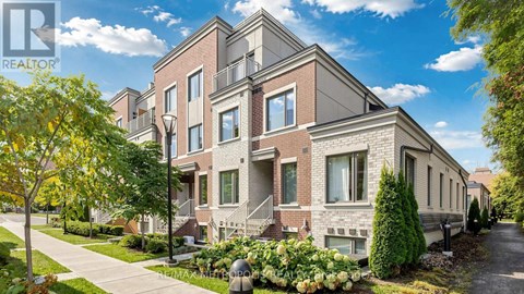 A row of houses with a realtor logo in the corner.