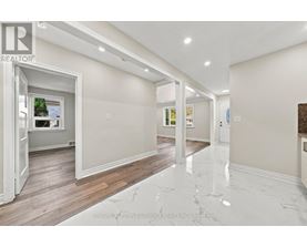 A spacious room with marble flooring and white walls.
