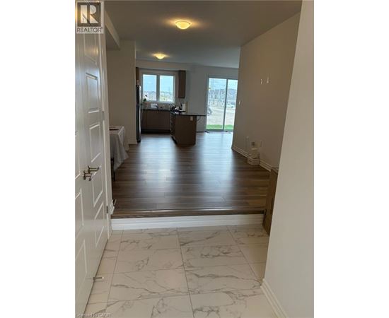 A realtor's photo of a room with a kitchen and a dining table.