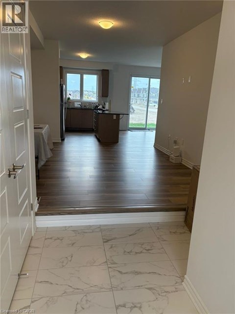 A realtor's photo of a room with a kitchen and a dining table.
