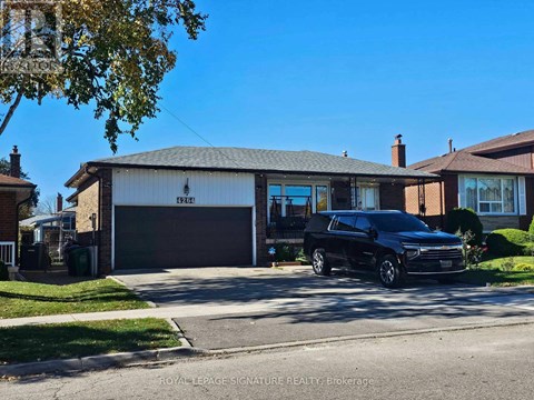 A black car is parked in front of a garage with the sign "Royal LePage Signature Realty Brokerage" on the building.