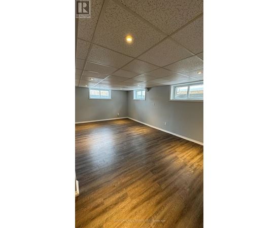 A room with wooden flooring and white walls.