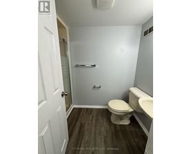 A bathroom with a toilet, sink, and bathtub.