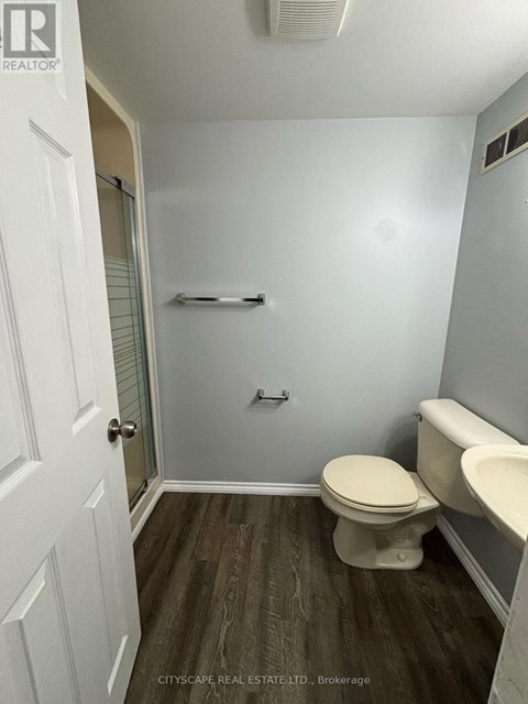 A bathroom with a toilet, sink, and bathtub.