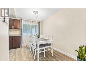 A dining room with a table set for four.