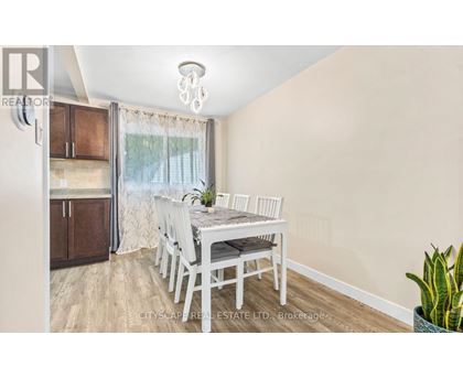 A dining room with a table set for four.