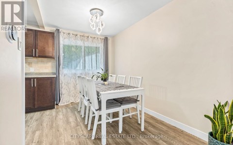 A dining room with a table set for four.