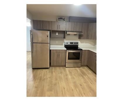 A kitchen with a stainless steel refrigerator and oven.