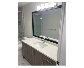 A bathroom with a sink and mirror.