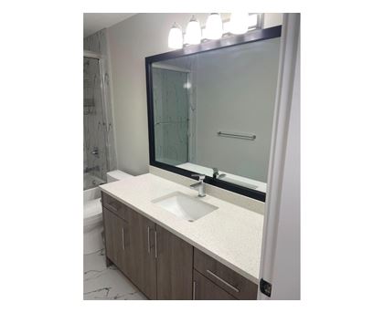 A bathroom with a sink and mirror.