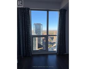 A window with a view of a cityscape and buildings.