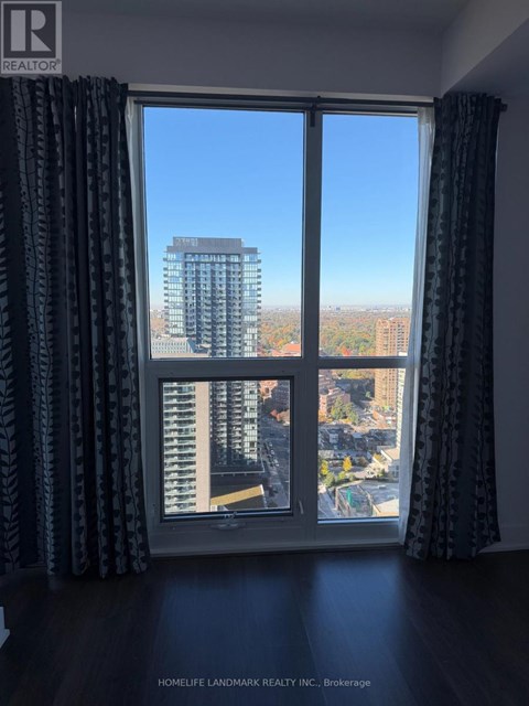A window with a view of a cityscape and buildings.