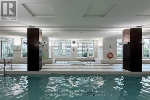 A pool area with a diving board and a bench.