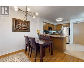 A kitchen with a dining table and chairs.