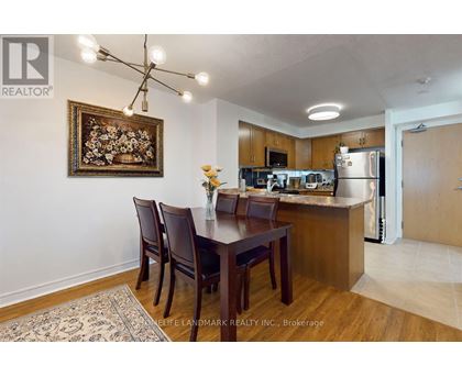 A kitchen with a dining table and chairs.