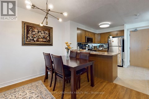 A kitchen with a dining table and chairs.