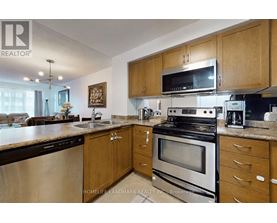 A kitchen with wooden cabinets and stainless steel appliances.