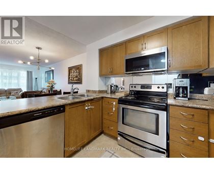 A kitchen with wooden cabinets and stainless steel appliances.