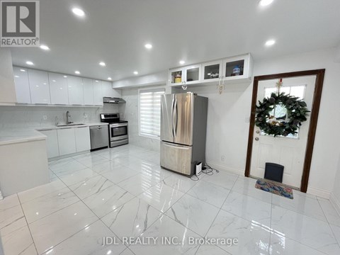 A kitchen with white cabinets and a marble floor.