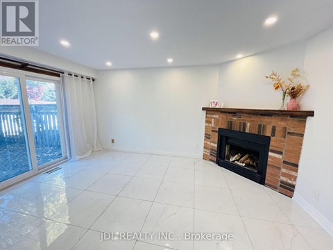 A spacious living room with a fireplace and sliding glass doors.