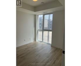 A room with a sliding glass door leading to a balcony.