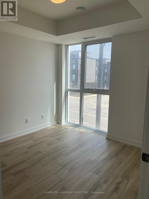 A room with a sliding glass door leading to a balcony.