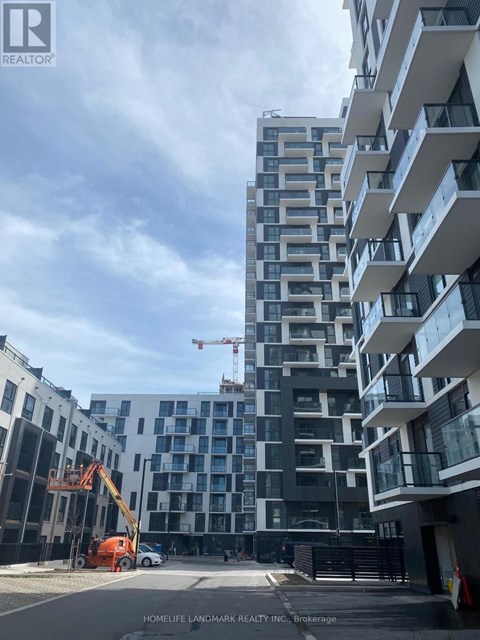A construction site with a crane and a building under construction.