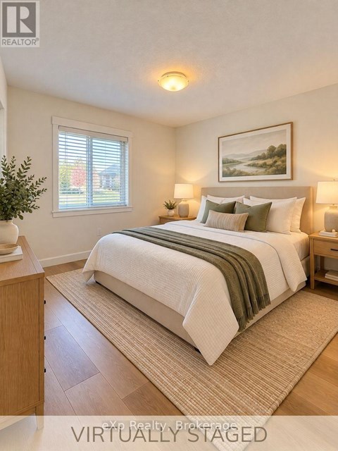 A bedroom with a bed, nightstands, and a painting on the wall.