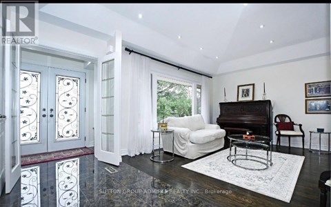 A living room with a piano and a white sofa.
