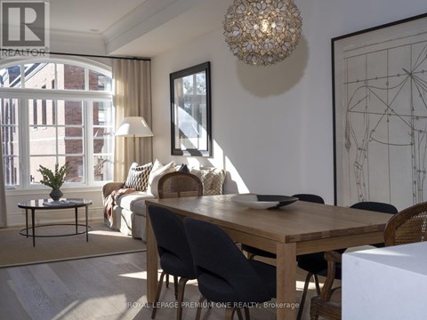 A dining room with a wooden table and chairs.