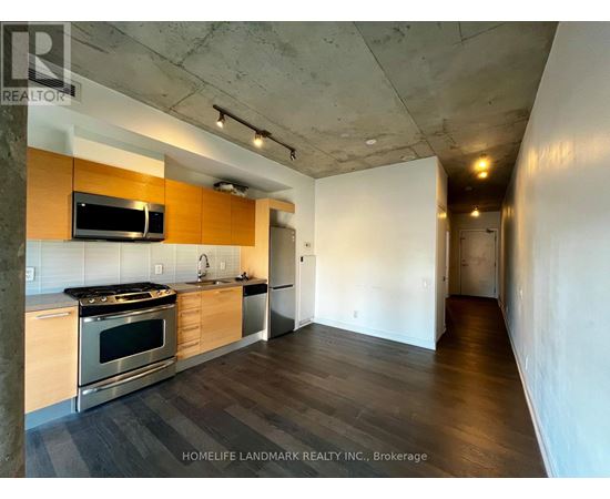A kitchen with a stove top oven and microwave built into a counter.