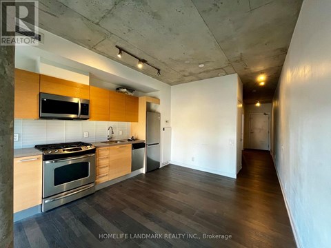 A kitchen with a stove top oven and microwave built into a counter.