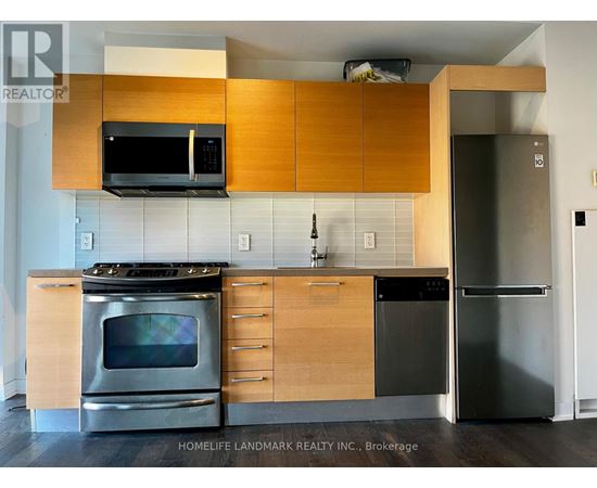 A kitchen with wooden cabinets and stainless steel appliances.