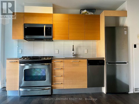 A kitchen with wooden cabinets and stainless steel appliances.