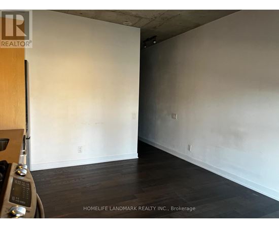 A room with wooden floors and white walls, with a logo for HomeLife Landmark Realty Inc. in Brokerage.